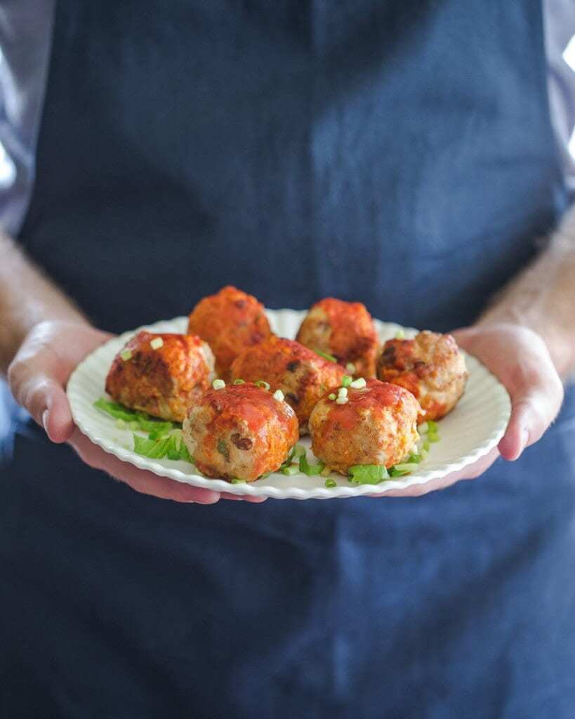 Buffalo Chicken Meatballs recipe from the cookbook, All-American Paleo Table by Caroline Potter. A perfect game-day snack or dinner. Superbowl food at its best (and healthy too!)