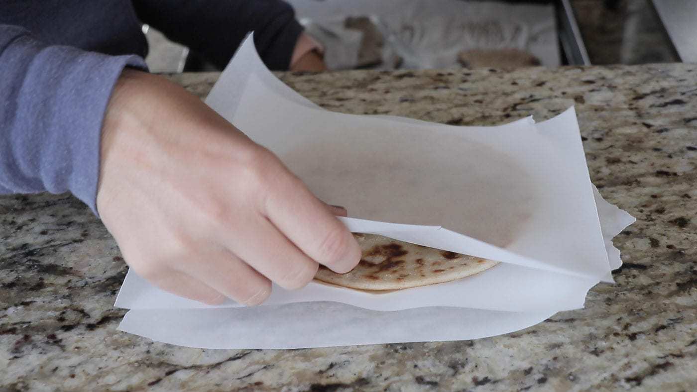 laying parchment paper in between pieces of AIP flatbread
