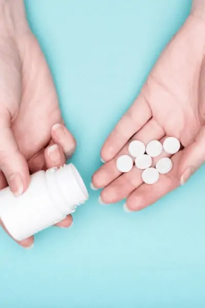 thyroid pills in a woman's hand