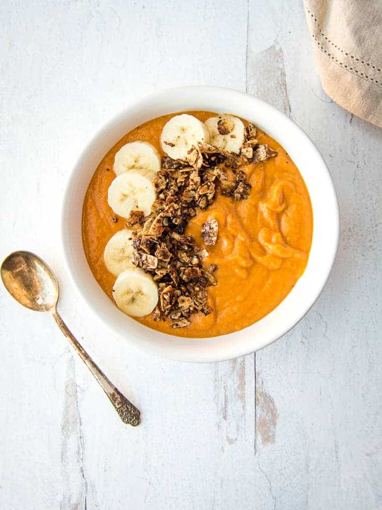 Sweet Potato Breakfast Bowl from above, covered with fresh banana slices and tigernut granola