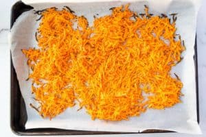 a sheet pan with grated roasted sweet potatoes