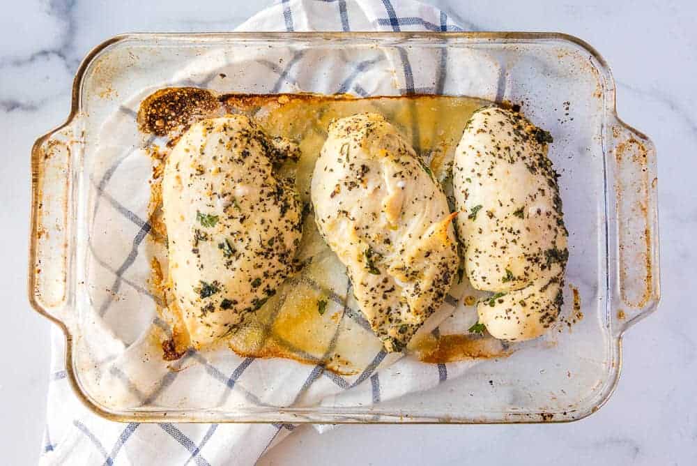 the roasted chicken breasts in a glass baking dish