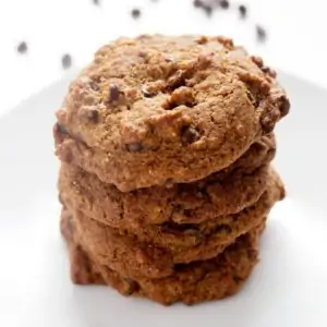4 AIP Chocolate Chip Cookies stacked on top of each other on a white plate