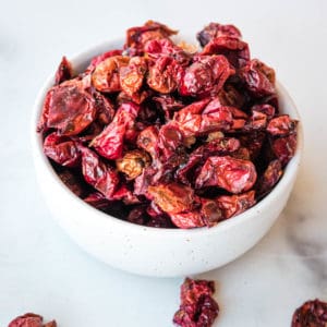 dried cranberries piled high in a small white bowl