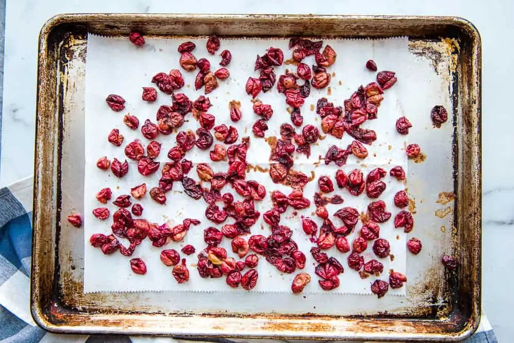 finished dried cranberries spread out on a baking sheet