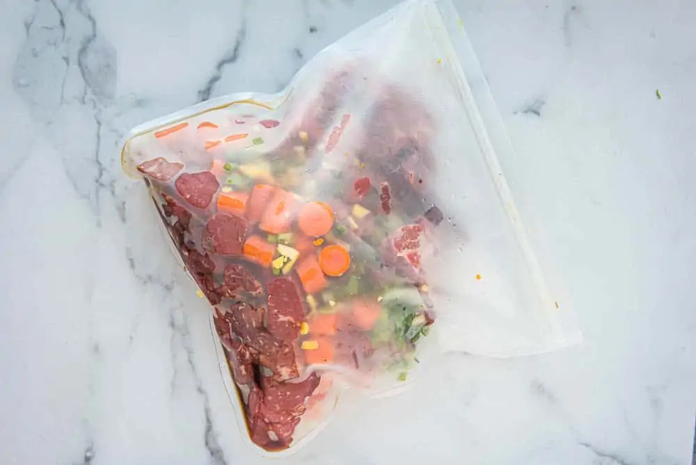 uncooked orange ginger beef in a freezer bag ready to go in the freezer