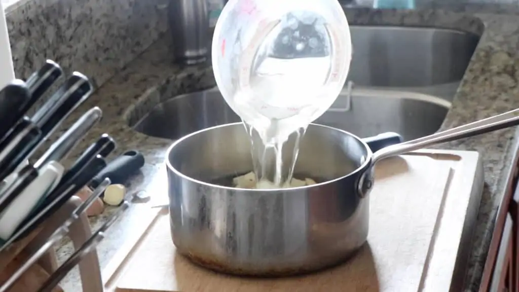 pouring fresh water into a pot