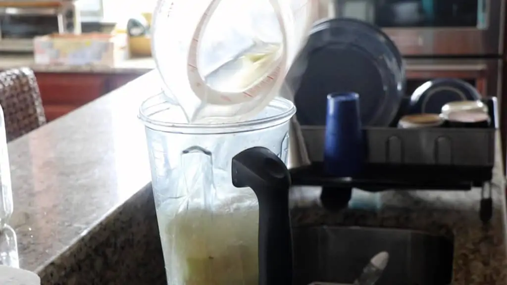 pouring the water into the blender